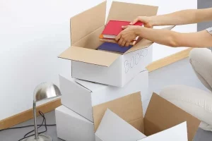 Books are being stored in cardboard boxes